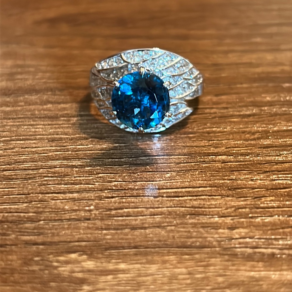Sterling silver ring with peacock blue gemstone and clear stones.  Size 9.5